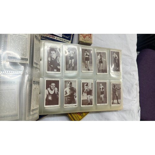 209 - Selection of cigarette card loose as well as an album of cards together with some vintage empty tins