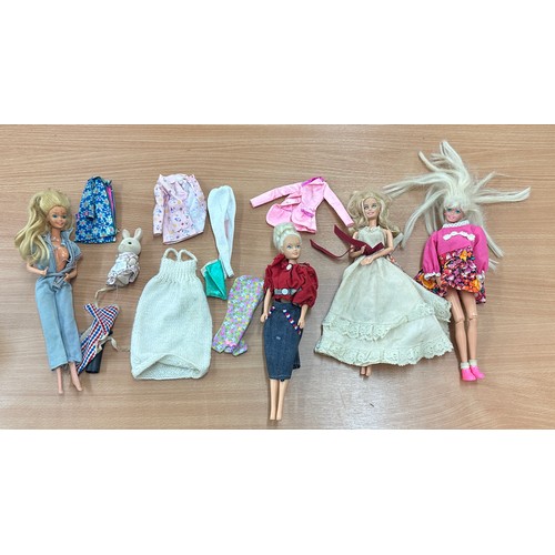 125 - Selection of 4 vintage Barbie dolls with outfits