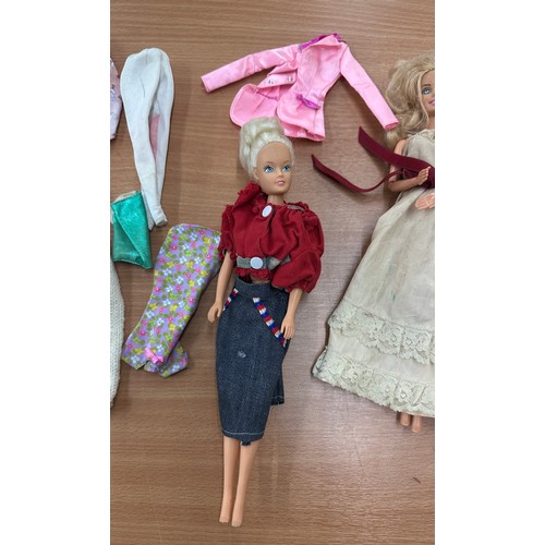 125 - Selection of 4 vintage Barbie dolls with outfits