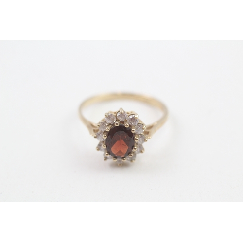 187 - 9ct gold garnet and cubic zirconia halo dress ring (2.6g)