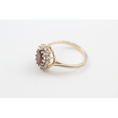 187 - 9ct gold garnet and cubic zirconia halo dress ring (2.6g)