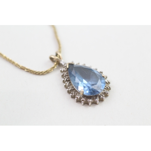 142 - 9ct gold diamond accented pear cut blue gemstone set cluster pendant necklace (4g)