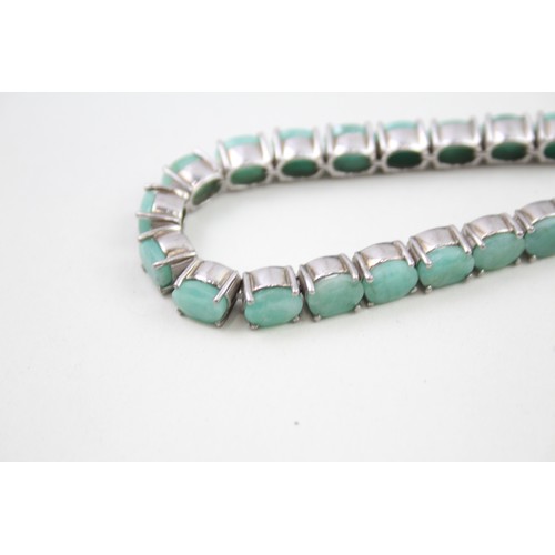 285 - A silver moonstone bracelet and an emerald tennis bracelet (33g)