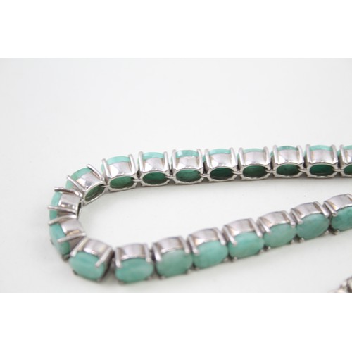 285 - A silver moonstone bracelet and an emerald tennis bracelet (33g)