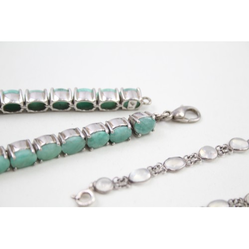 285 - A silver moonstone bracelet and an emerald tennis bracelet (33g)