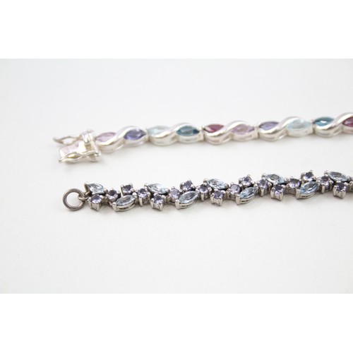 293 - Two silver stone set tennis bracelets including topaz and tanzanite (22g)