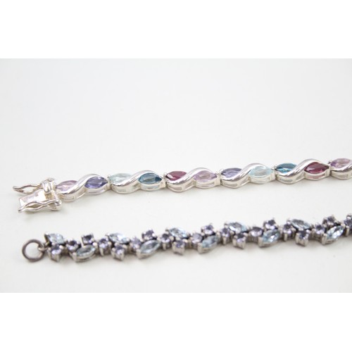 293 - Two silver stone set tennis bracelets including topaz and tanzanite (22g)