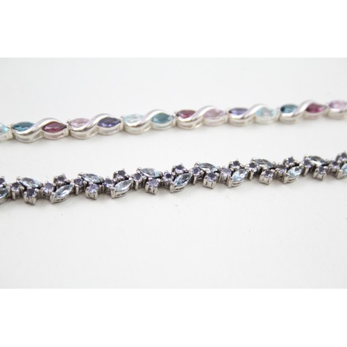 293 - Two silver stone set tennis bracelets including topaz and tanzanite (22g)