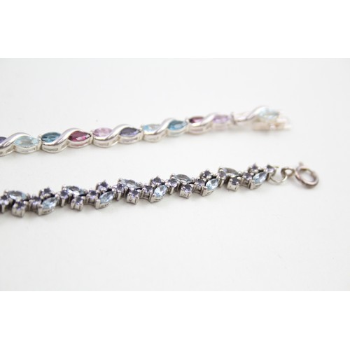 293 - Two silver stone set tennis bracelets including topaz and tanzanite (22g)