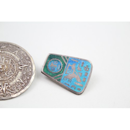 296 - Three silver souvenir brooches including Mayan calander, Laffi and Taxco (36g)