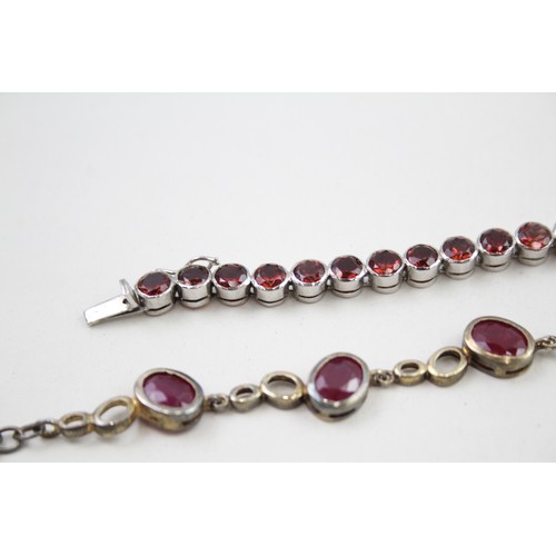 300 - Two silver stone set tennis bracelets including ruby and garnet (37g)