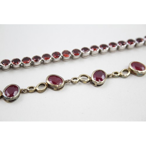 300 - Two silver stone set tennis bracelets including ruby and garnet (37g)