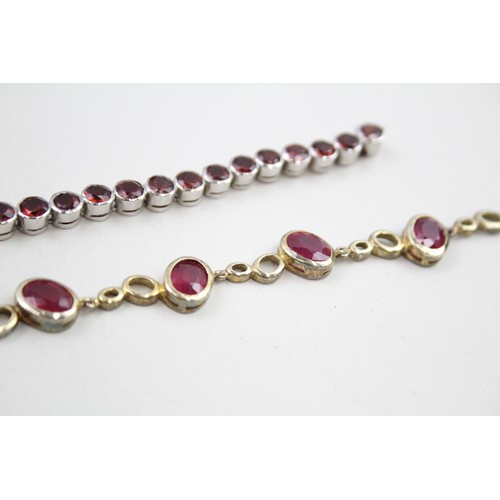 300 - Two silver stone set tennis bracelets including ruby and garnet (37g)