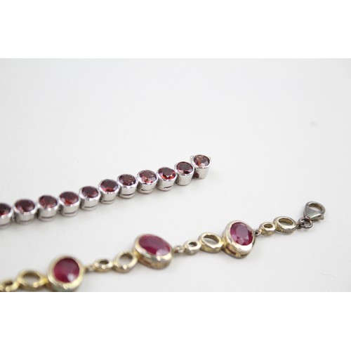 300 - Two silver stone set tennis bracelets including ruby and garnet (37g)