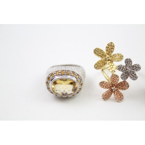 310 - Four silver stone set cocktail rings including diamond and opal (33g)