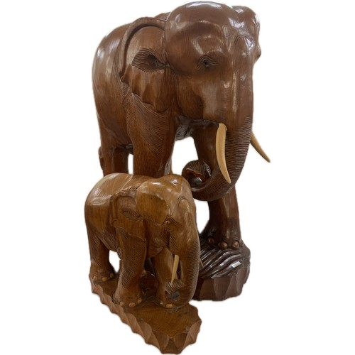 273 - Large wooden carved elephant figure and a small carved wooden elephant- largest measures approx 25 i... 