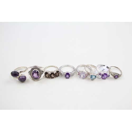 306 - A collection of silver stone set rings including amethyst and topaz (30g)