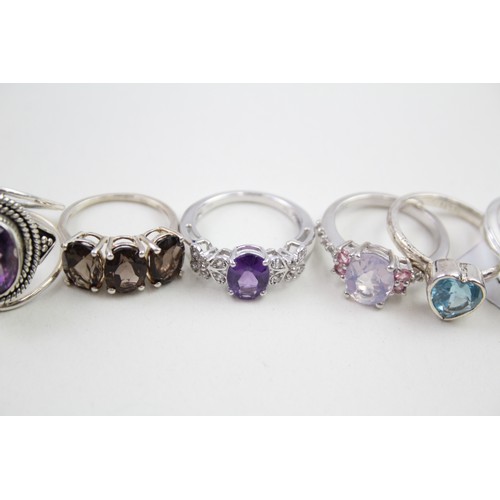 306 - A collection of silver stone set rings including amethyst and topaz (30g)