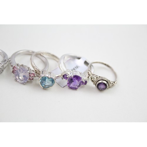 306 - A collection of silver stone set rings including amethyst and topaz (30g)