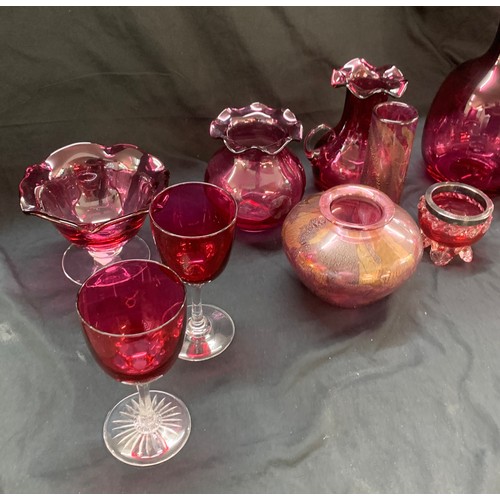 24 - Selection of cranberry glass ware to include a decanter, jugs, trifle dishes etc