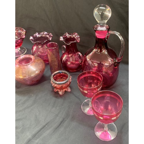 24 - Selection of cranberry glass ware to include a decanter, jugs, trifle dishes etc