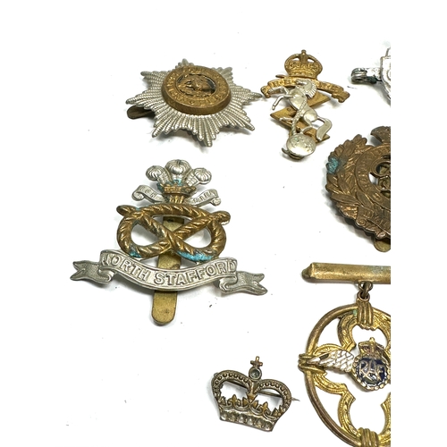 364 - selection of military badges & cap badges