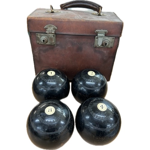 80 - A set of four early wooden lawn bowls, signed Thomas Taylor Glasgow within a leather carrying case.