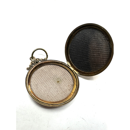 114 - Antique 9ct gold back & front locket measures approx 3.5cm drop by 2.9cm dia