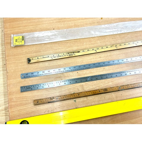 143 - Selection of assorted measuring equipment includes Level, rulers etc