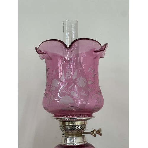 635 - Silver plated column base walker and hall oil lamp with cranberry glass shade total height approxima... 