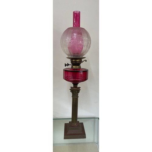 639 - Antique column base oil lamp with cranberry glass, total height 30 inches