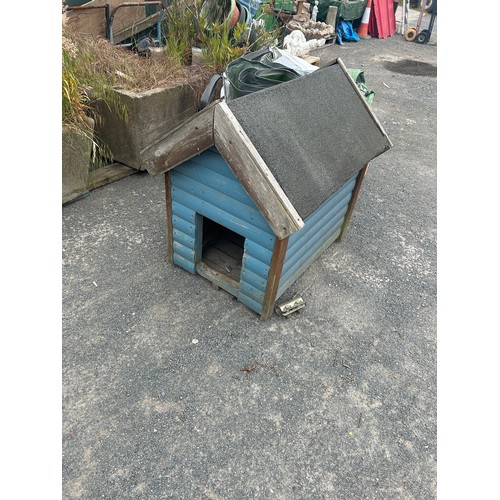 90 - Wooden dog house measures approx 41 inches tall by 34 wide and 43 long