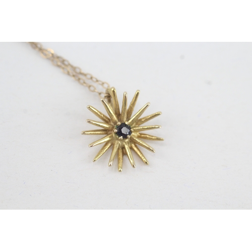 210 - 9ct gold sapphire set starburst pendant necklace (2.1g)