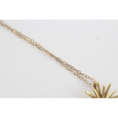 210 - 9ct gold sapphire set starburst pendant necklace (2.1g)