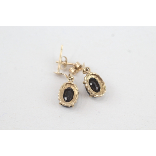 130 - 9ct gold oval cut sapphire drop earrings with scroll backs (1.1g)
