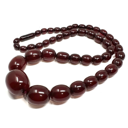 99 - Cherry amber / bakelite bead necklace with internal streaking largest bead measures approx 27mm by 2... 