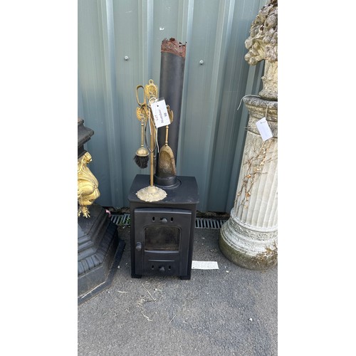 18 - Log burning fire stove and a companion set 18 inches tall 13 inches depth 18 inches wide