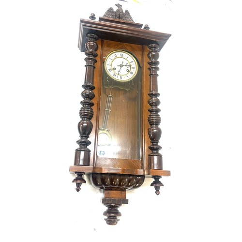 24 - Two key hole wall hanging carved wooden clock with key and pendulum