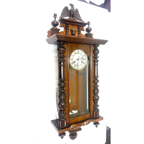 24 - Two key hole wall hanging carved wooden clock with key and pendulum