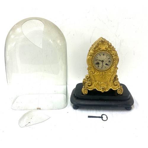 30 - Victorian brass clock on stand under glass dome - dome has sustained damage.
Overall height 16.5 inc... 