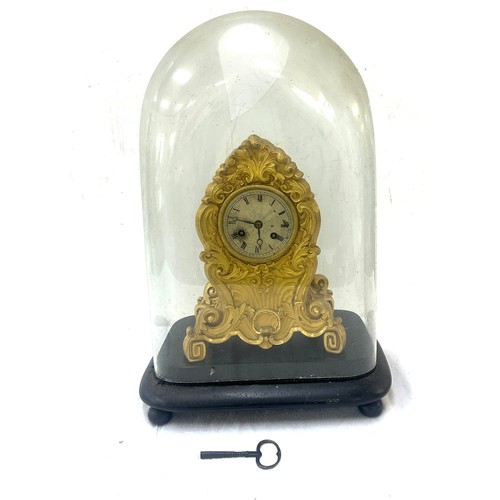 30 - Victorian brass clock on stand under glass dome - dome has sustained damage.
Overall height 16.5 inc... 