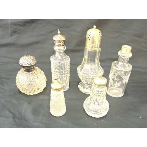 88 - Six glass bottles with silver and silver plate tops tallest measures approx 6.5 inches