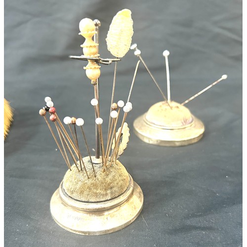 554 - Two silver hair brushes one has a loose mirror and two silver hat pin stands to include hat pins