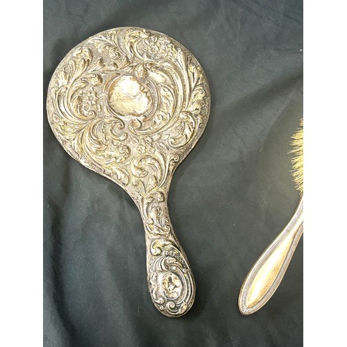 554 - Two silver hair brushes one has a loose mirror and two silver hat pin stands to include hat pins