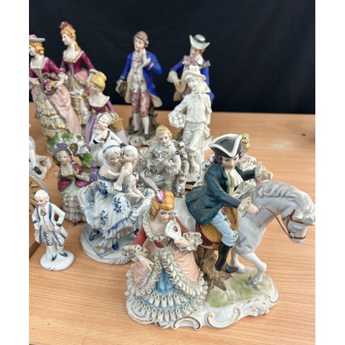 113 - Large selection of vintage porcelain lady and gent figures and a musical carriage figure  tallest me... 