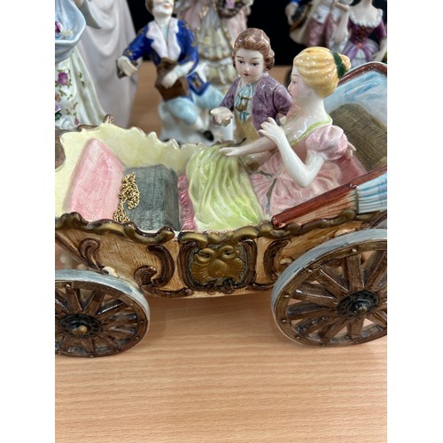 113 - Large selection of vintage porcelain lady and gent figures and a musical carriage figure  tallest me... 