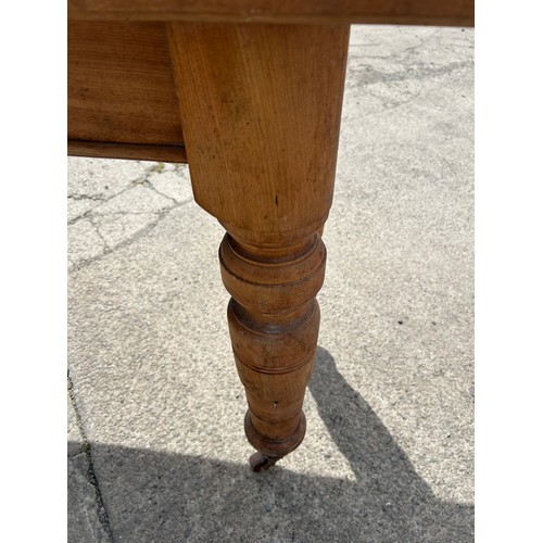 385 - Beech Edwardian table on castors measures approx 38 inches long, 21 wide and 30 tall