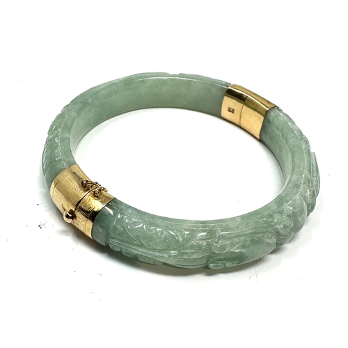 90 - 14ct gold carved jade bangle weight 58g