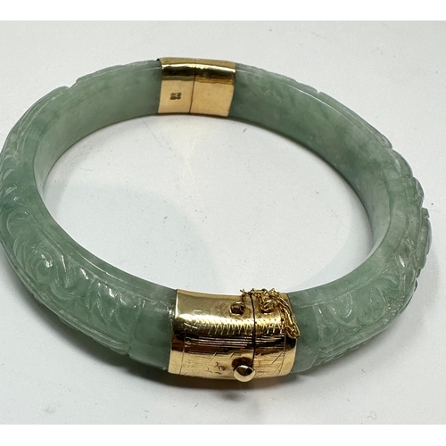 90 - 14ct gold carved jade bangle weight 58g