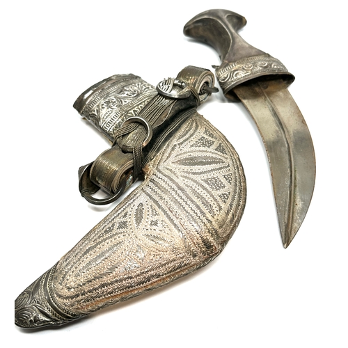 472 - Eastern Jambiya dagger The blade measuring 15 cm long. finely worked white metal and leather. Set wi... 